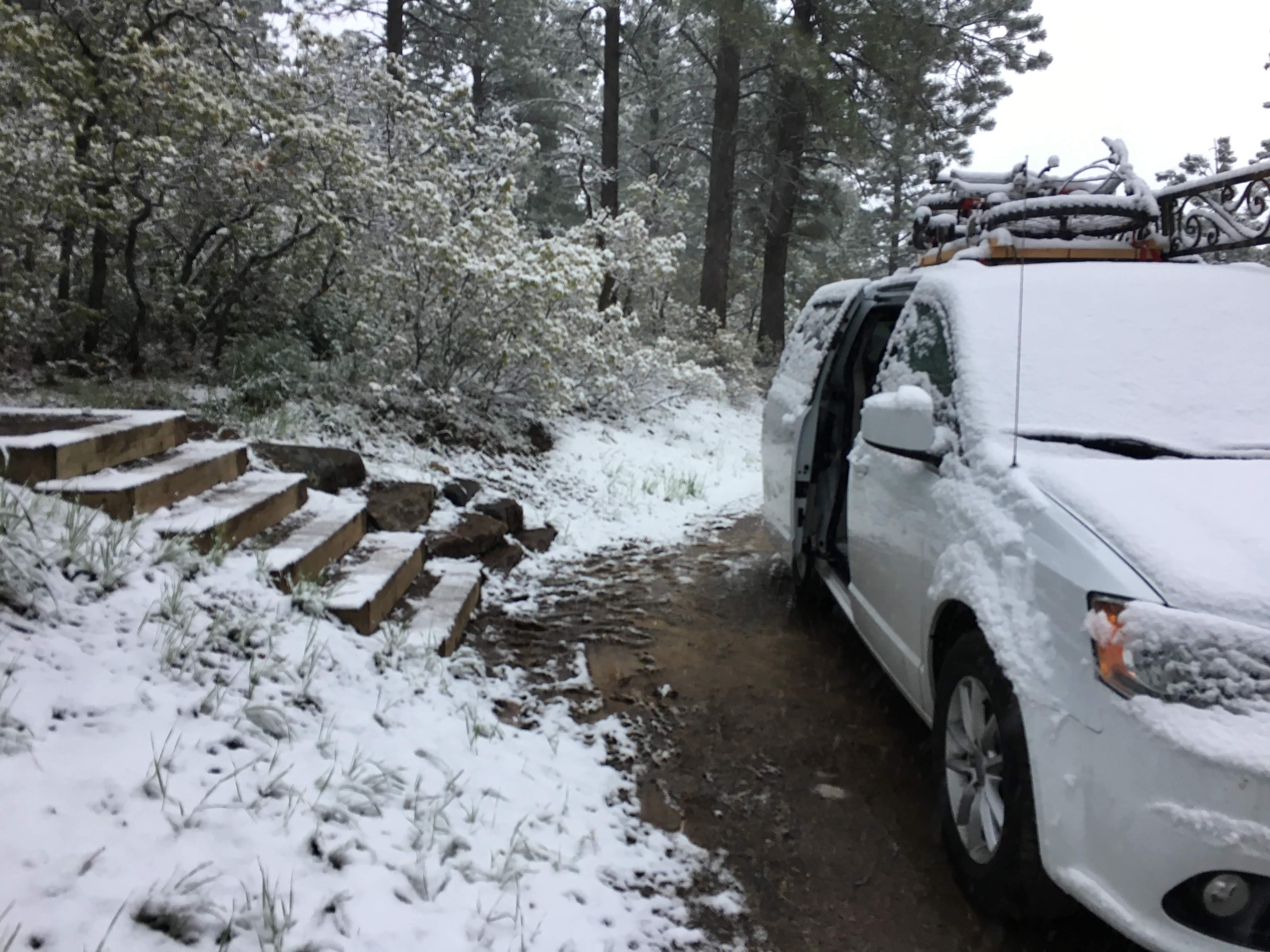 Snow covered van and pathway to the campsite