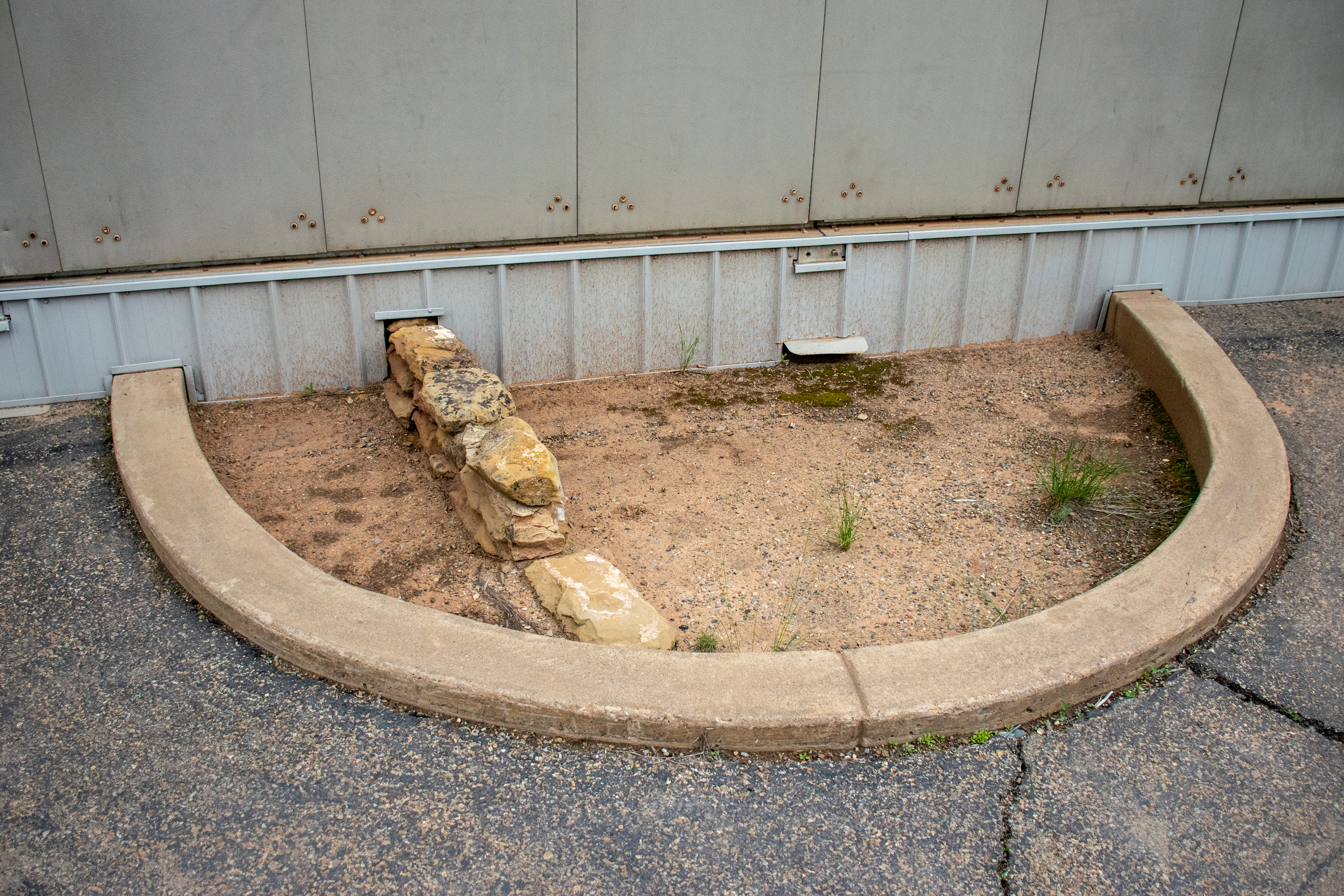Puble indian ruins sticking out of a building meant to protect the ruins