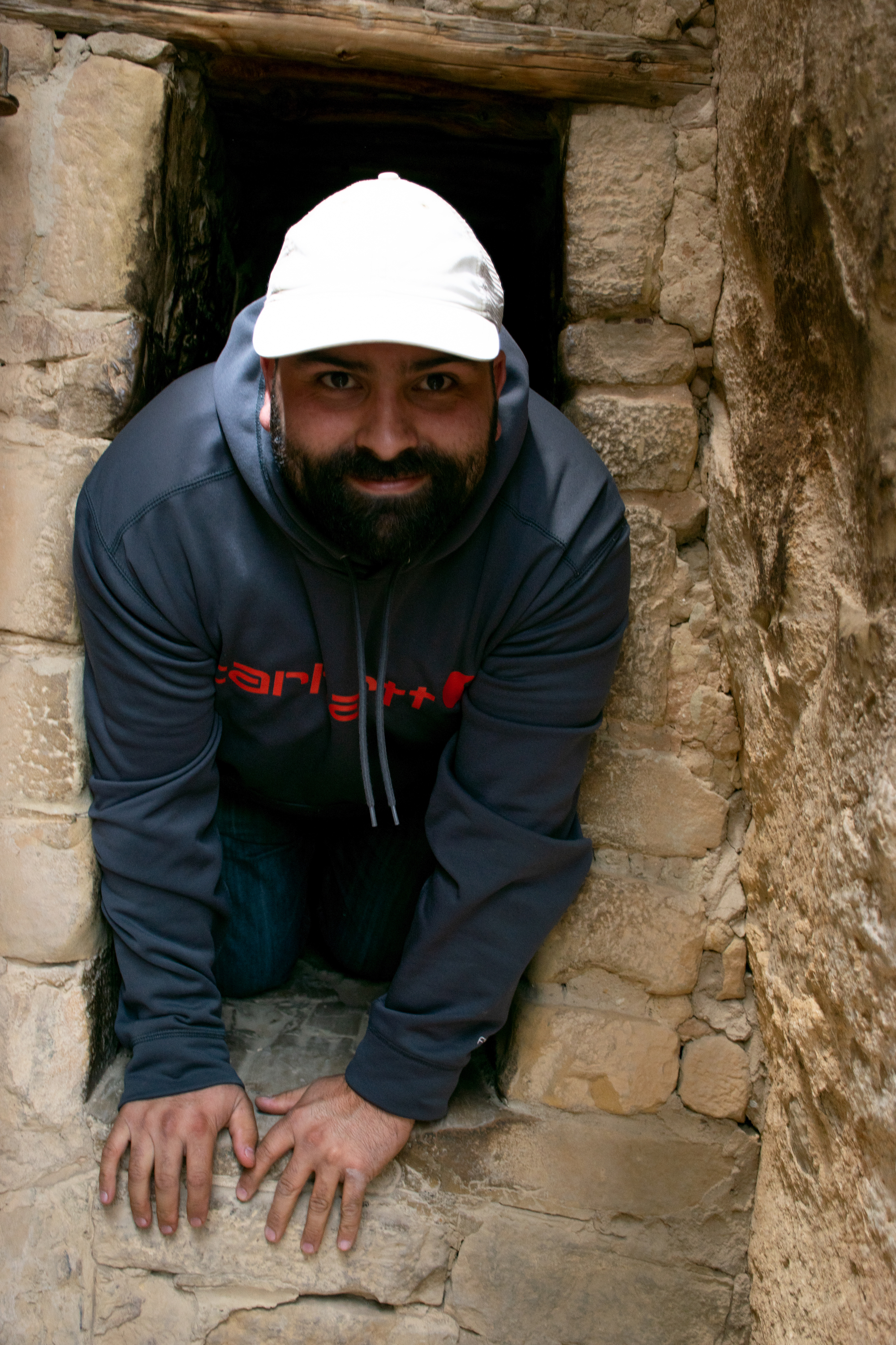 Aaron climbing through the tunnel out of Balcony House